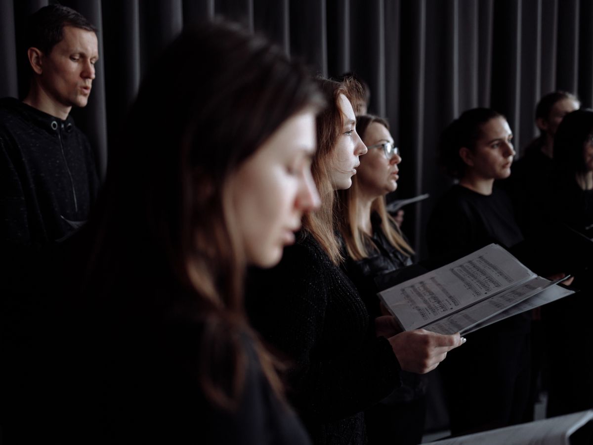 A choir singing together from sheet music